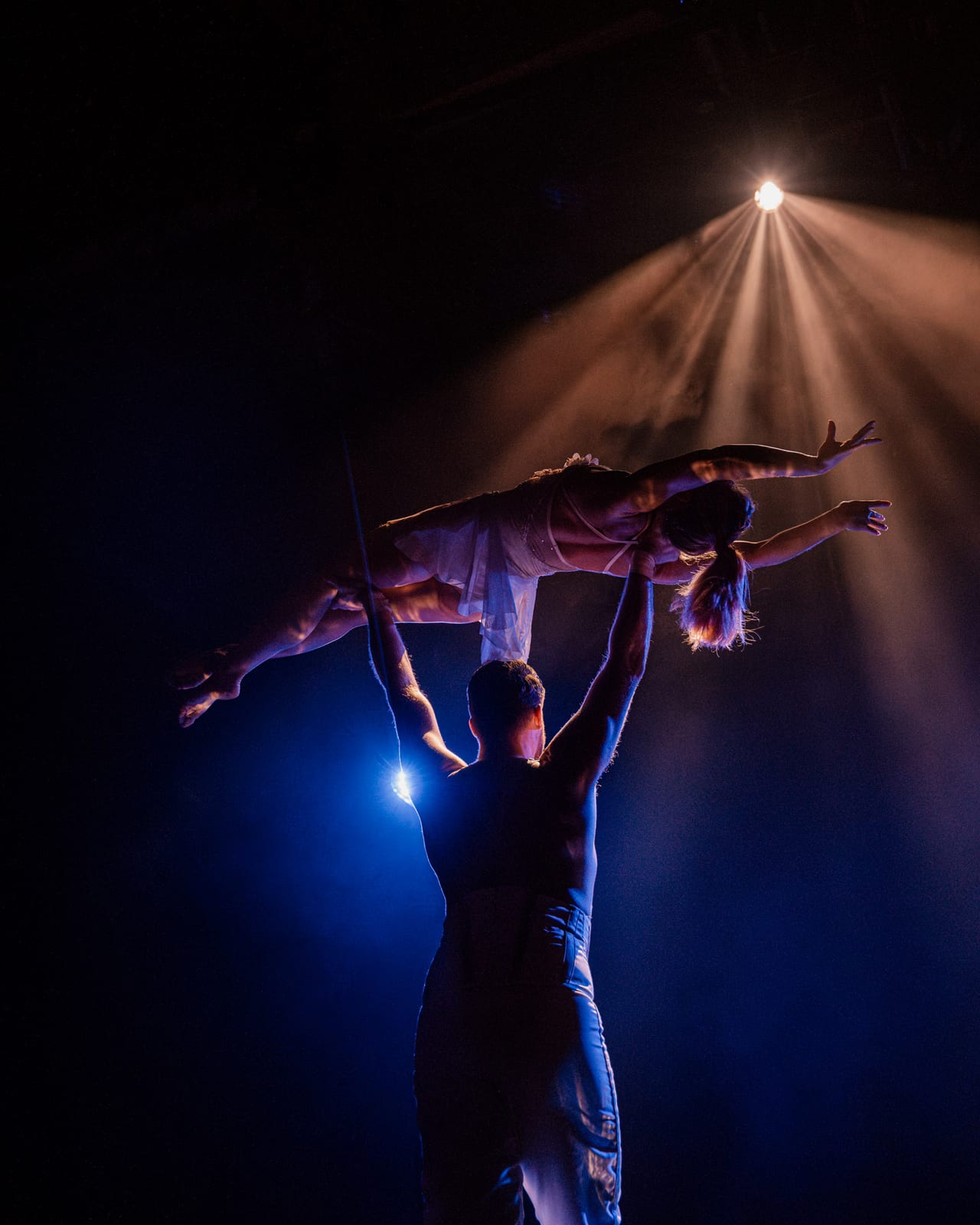 Cirque Bon Bon: aerial circus performer lit by Krank’d-hired moving-head fixtures and haze