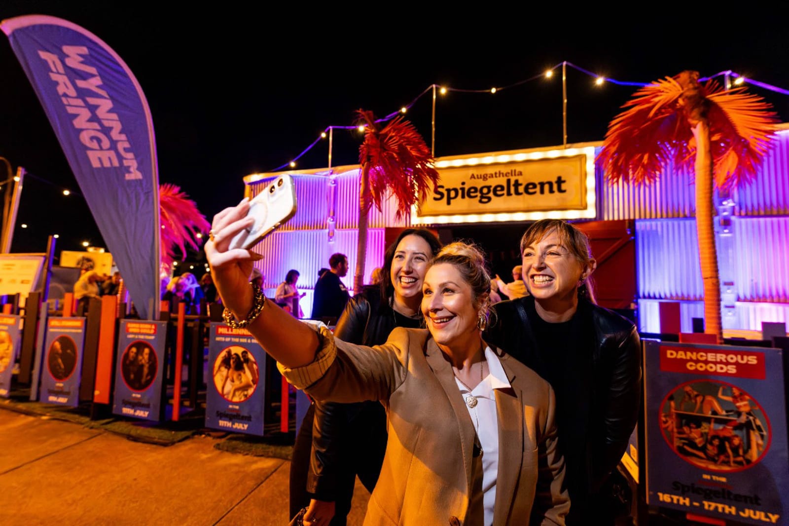 Outdoor festival stage lit by weatherproof fixtures after dark
